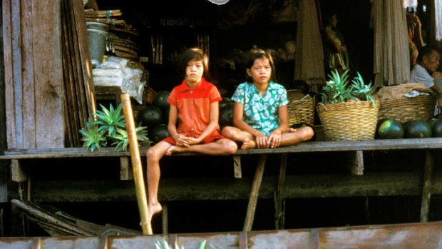 Thai children in a canal side store.
