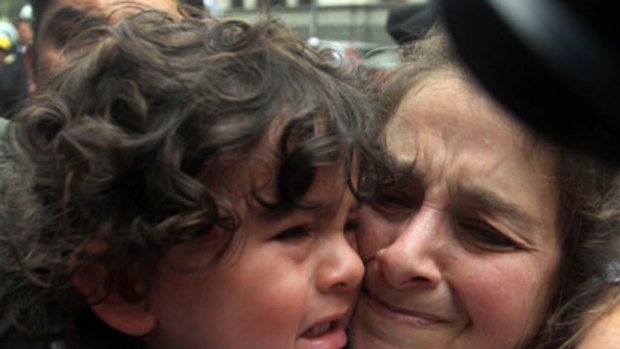 Trauma ... Lori Berenson clutches her son as she is hounded by media on her arrival at the courthouse jail in Lima yesterday.