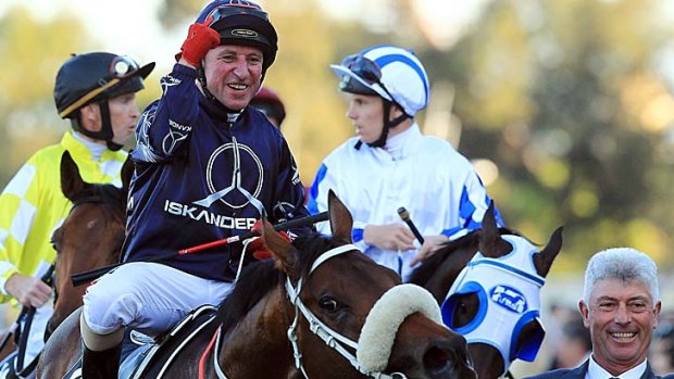 Winners are grinners: Jim Cassidy celebrates his win aboard Zoustar at Rosehill on Saturday.
