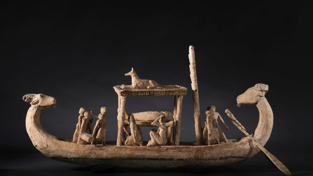 This funerary boat from Ancient Egypt represents the transport of the dead to the afterlife across the Nile, guided by dog figure Anibus.