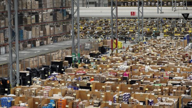 Parcels are processed and prepared for dispatch at an Amazon fulfilment centre in Peterborough, England.