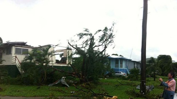 A thunderstorm described as a mini-tornado has torn apart Townsville homes.