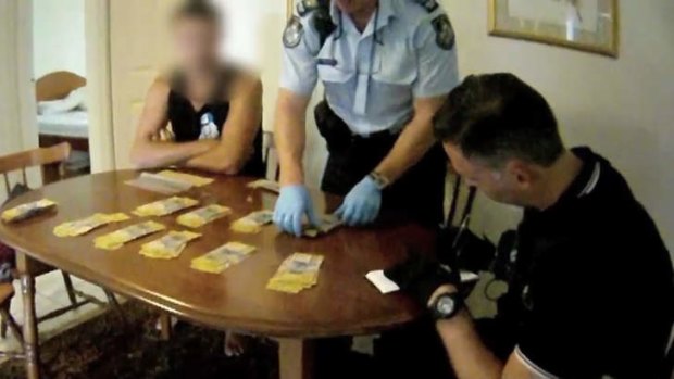 Police at Algester seize cash, drugs, alleged fake IDs during raid on man linked to Bandidos bikies