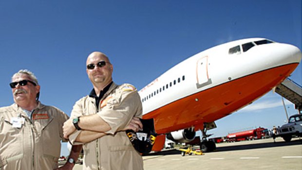 Pilots Captain Jack Maxey, left, and Captain Kevin Hopf in front of the DC-10 water bomber, Victoria's latest weapon in bushfire fighting.