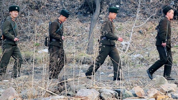 North Korean soldiers patrol along the bank of the Yalu River in the North Korean town of Sinuiju across from the Chinese city of Dandong.