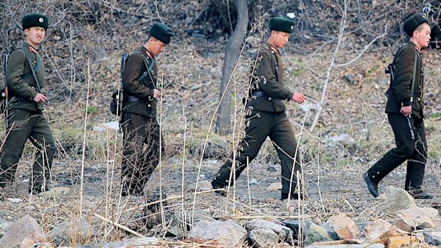 North Korean soldiers patrol along the bank of the Yalu River in the North Korean town of Sinuiju across from the Chinese city of Dandong.