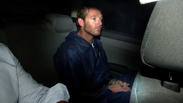 'Assaulted' ... Ian David Thomas, leaves the St Kilda Road police headquarters, charged with murdering his parents.