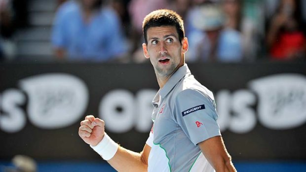 Looking back in happiness: Novak Djokovic has the beginnings of a smile on his face after a comprehensive fourth-round win over Fabio Fognini on Sunday.