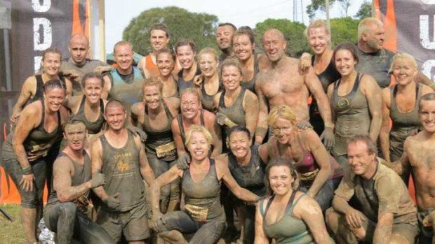 Maxine Windram, "the little one" to the left of the man with no top, with her group of 30 at the Phillip Island Tough Mudder event earlier this year.