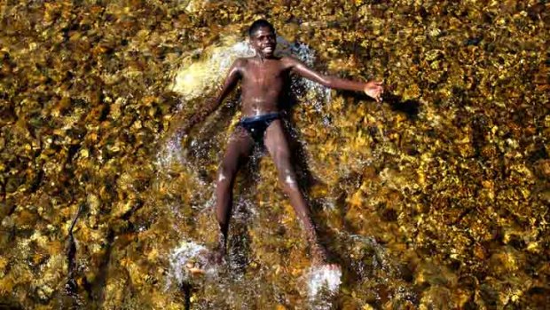 Cletus Nemarluk takes a dip in the Moyle River on the way to Perrederr.