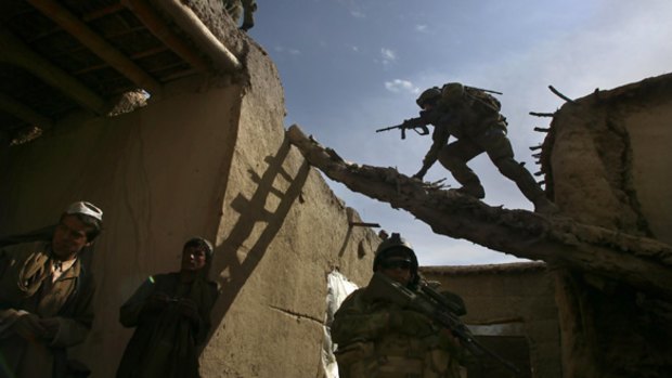 Australian and ANA soldiers search a Qala compound in Chora.