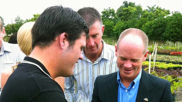 LNP leader Campbell Newman gets some green thumbs advice from Andrew Saggers while visiting HELP Enterprise's Oxford Park nursery in Mitchelton.