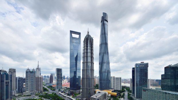 The Shanghai skyline features dramatic skyscrapers.