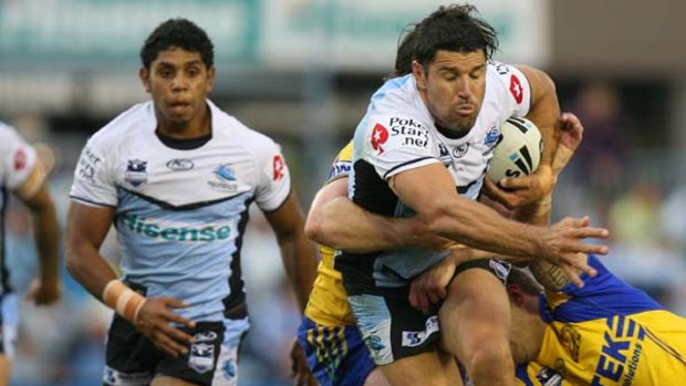 Trent Barrett of the Sharks charges at the Eels's defence.