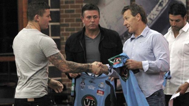 Handover ... Melbourne coach Craig Bellamy gives Blues five-eighth Todd Carney his State of Origin game jersey last night after Ricky Stuart asked his predecessor to take part in what is an important ritual for NSW.