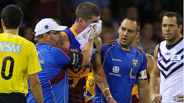 In the wars: collison-attractor Jonathan Brown suffers a heavy blow against fremantle in 2011.