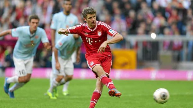 Thomas Mueller scores from the penalty spot for Bayern Munich.