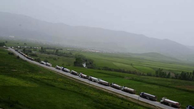 Fuel tankers loaded with oil from Iraqi Kurdistan wait near the Iranian border to illegally export fuel in Penjwin, Iraq. <i>Photo: Ayman Oghanna/The New York Times</i>