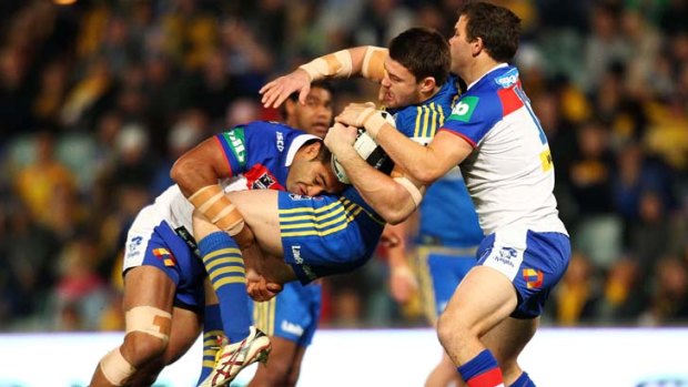 Feeling the brunt of an eager Knights defence ... Parramatta's Mitchell Allgood.