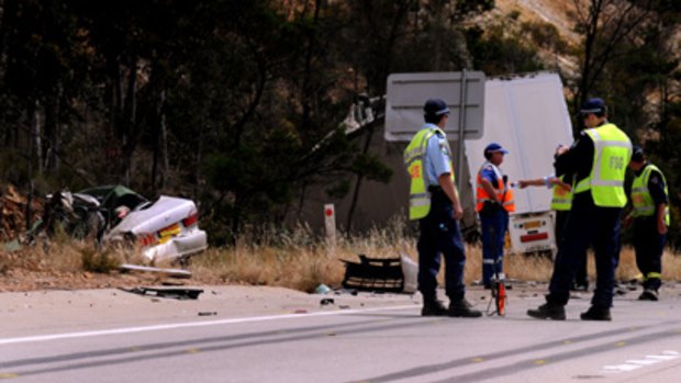 Authorities at the crash scene north of Yass yesterday, where four men in their 20s were killed when their car collided with a semi-trailer.
