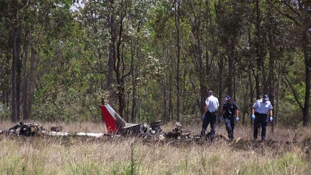 Police scan the plane wreckage.