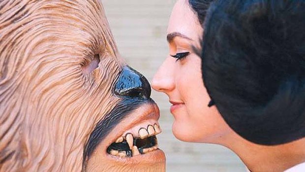 "Chewbacca" and "Princess Leia" seal their marriage with a kiss during a Star Wars themed wedding.