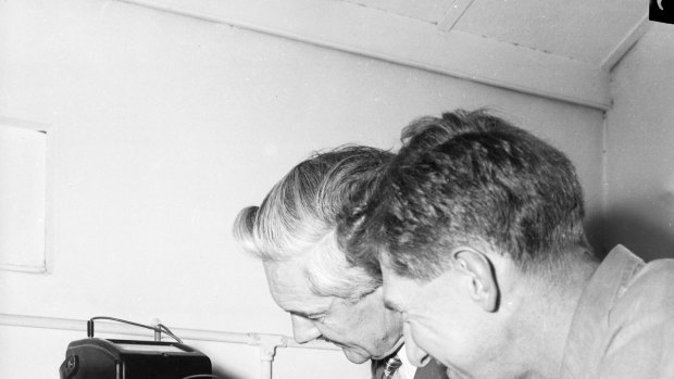 Officers at the CSIRO listen to the radio signals of Russian satellite, Sputnik I, at Sydney University, 8 October 1957. 