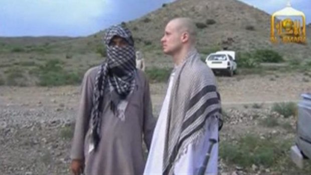 Bowe Bergdahl waits before being released at the Afghan border.