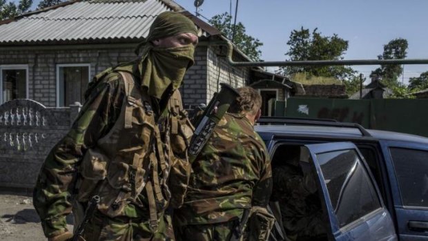 Pro-Russian militia climb into a car after fighting near Sergei Prokofiev International Airport in Donetsk, eastern Ukraine.