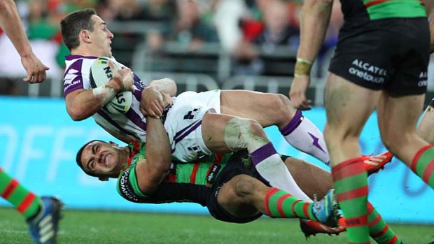 Back to earth: Melbourne Storm star Billy Slater is tackled during Friday night's controversial loss to South Sydney.