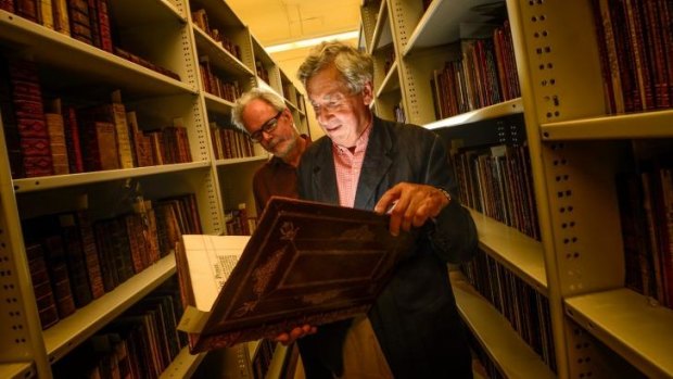 Des Cowley and David Emmerson with one of the donated books.