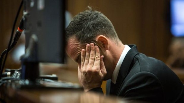 South African Paralympic athlete Oscar Pistorius sits in the dock on day eleven of his trial for the murder of his girlfriend Reeva Steenkamp.