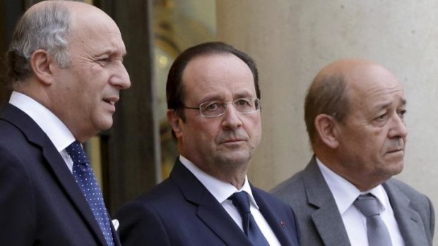 Francois Hollande, centre, with the Foreign Affairs Minister Laurent Fabius, left, and Defence Minister Jean-Yves Le Drian at the Elysee Palace in Paris this week.