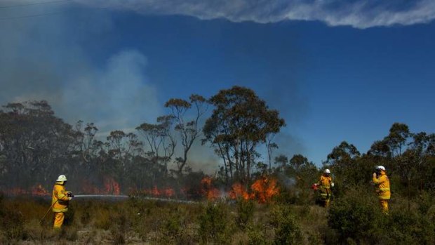 NSW RFS Crews continue to fight the State Mine fire on the Darling Causeway near Bell as they back burn onto the fire front.