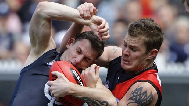 Then- Bombers forward Kyle Reimers tackles Blues defender Heath Scotland in 2011.