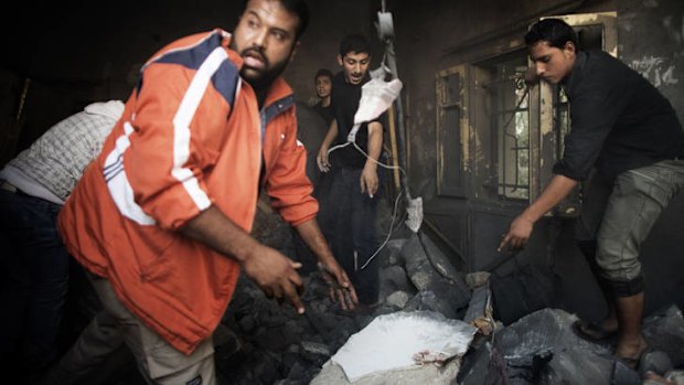 Palestinians point a the spot where they believe the children of  the Dallu family are trapped.