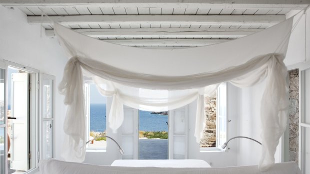 Shrouded in floating white muslin, the bedroom opens onto a terrace and has a breathtaking view of the Aegean.