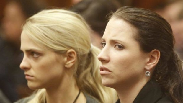 Aimee Pistorius (R), the sister of Oscar Pistorius, reacts during the fifth day of the South African paralympic athlete's murder trial.
