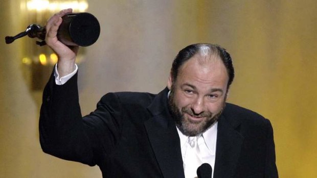 James Gandolfini holds up his Emmy award for Outstanding Performance by a Male Actor in a Drama Series in 2008.