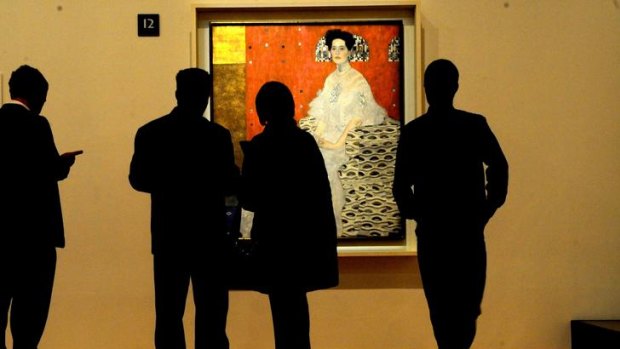 Visitors view a painting by Gustav Klimt in the NGV's 2011 exhibition  <i>Vienna: Art and Design</i>.