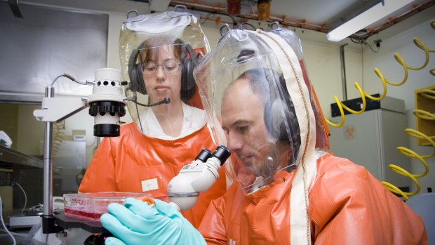 Scientists at the Australian Animal Health Laboratory working at Biosecurity Level 4, the highest security available.