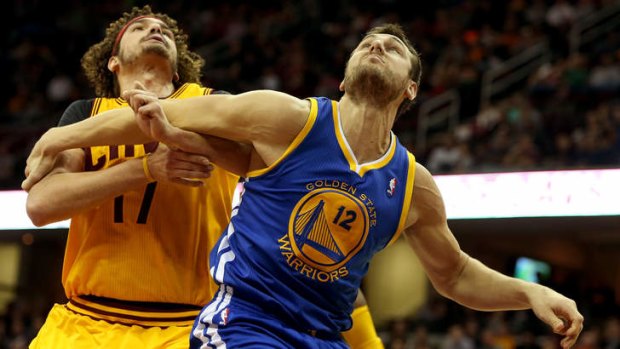Andrew Bogut fights for position with Cleveland's Anderson Varejao.