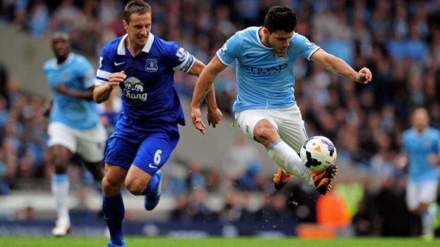 Too good: Sergio Aguero of Manchester City is pursued by Phil Jagielka of Everton.