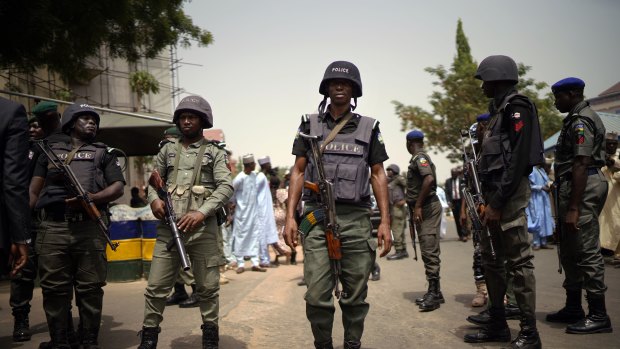 Nigerian police guard the entrance of the All Progressives Congress party while President Muhammadu Buhari holds an emergency meeting with senior members of the party in Abuja, Nigeria.