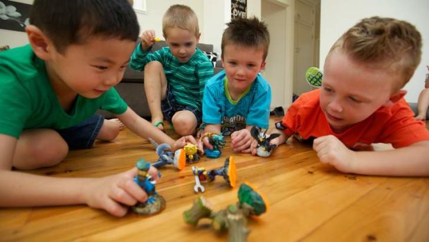 Enthralled: Ignatius Lo, Oliver Lette, Aiden Smith and Benjamin Smith play with the Skylanders figurines.