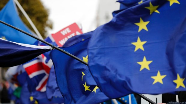 The EU and British flags wave at the demonstrations area near the parliament building in London, Wednesday, Jan. 16, 2019. British lawmakers overwhelmingly rejected Prime Minister Theresa May's divorce deal with the European Union on Tuesday, plunging the Brexit process into chaos and triggering a no-confidence vote that could topple her government. (AP Photo/Frank Augstein)