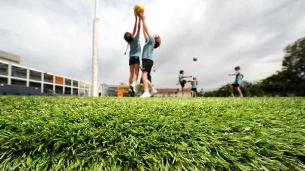 No watering, no mud, no mowing: students play on the synthetic grass of Geelong Grammar School's Toorak campus.