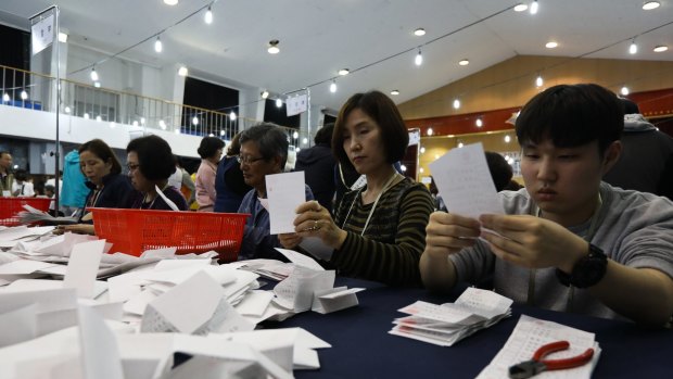 Electoral officials count ballots for the presidential election at a school in Seoul.