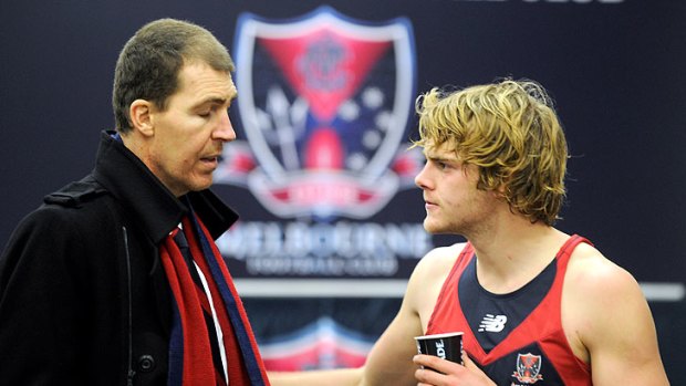 Chat time: Melbourne president Jim Stynes talks with player Jack Watts after yesterday's game.