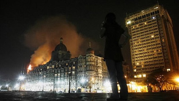 Large plumes of smoke rise from the top of the landmark Taj Hotel in Mumbai after it was targeted in the attacks.
